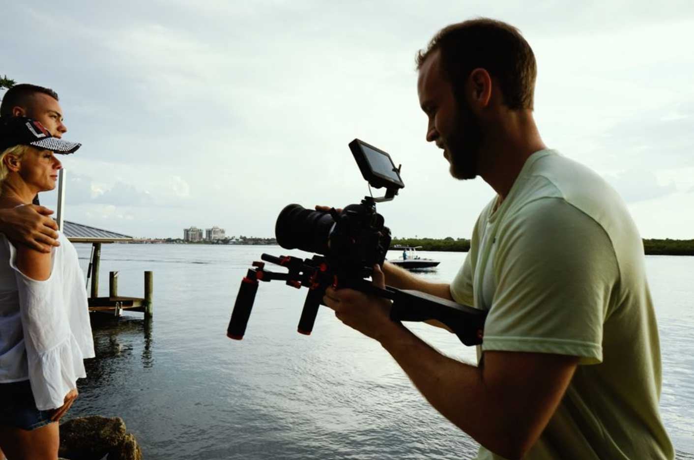 Two wedding videographers filming a ceremony from different angles at a Northern Ireland venue