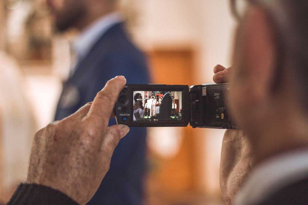 wedding videographer filming the bride on a camcorder at a Northern Ireland wedding